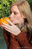 attractive-blond-woman-kisses-pumpkin-autumn-79587845.jpg